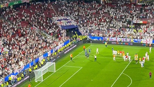 The England manager was unfazed by the cups and continued applauding as he walked past them.