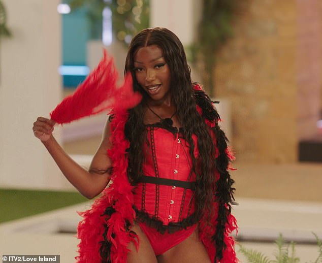 Mimii Ngulube stunned in a Moulin Rogue-inspired red corset as she took to the stage using a feather as a prop to mock the male islanders.