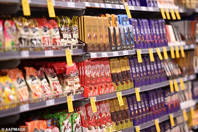 From July, Natural Confectionery Co. will begin supplying Australian retailers with bags of slippery snakes that contain 50 per cent less sugar (file image of Woolworths sweets aisle).