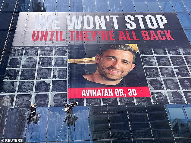 Avinatan Or's face appears on a tower displaying the faces of hostages in Israel on May 26.