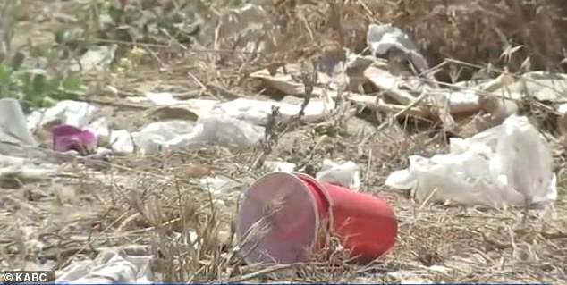 The video shows empty beer bottles, plastic cups, cardboard boxes and graffiti covering the once pristine hillside.