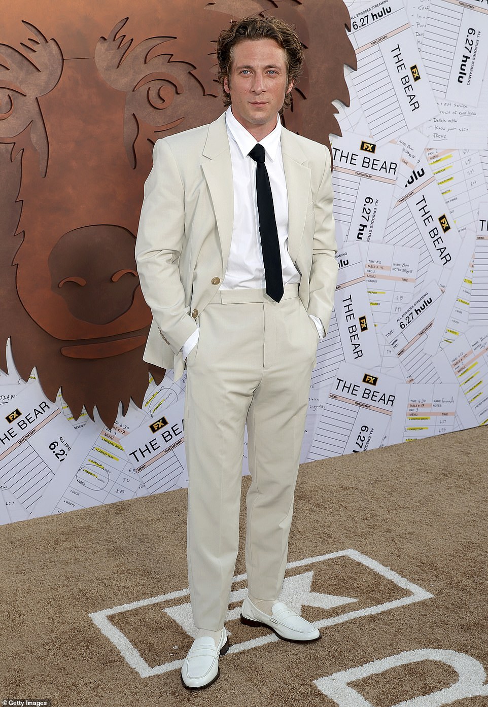 The New York native, 33, completed his look with a skinny black tie, a crisp white shirt, and white leather loafers.