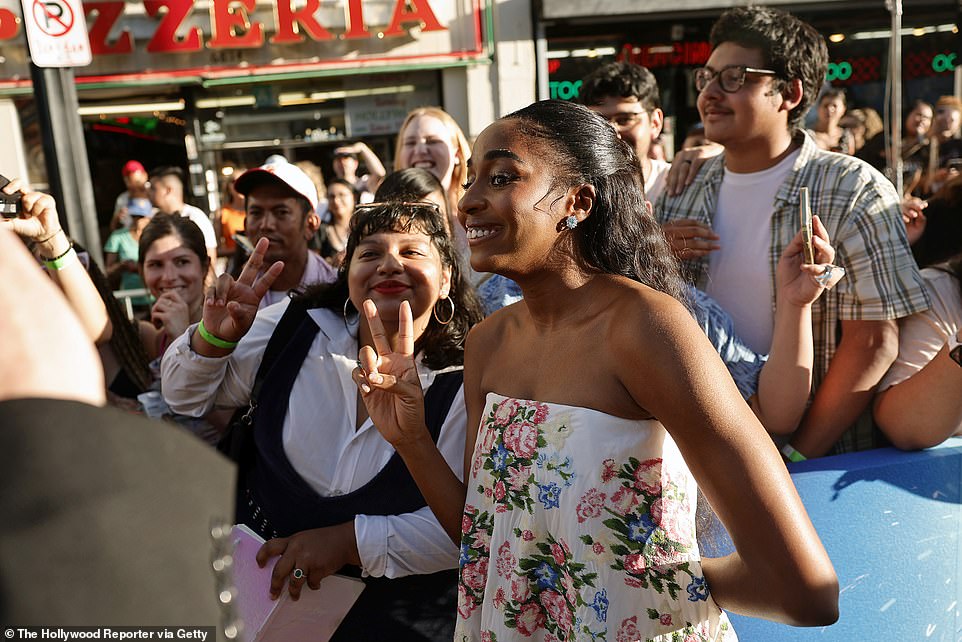 She happily posed for photos with fans before the screening.