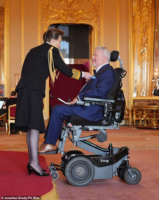 Princess Anne honors Michael McGrath, chief executive of the Muscle Help Foundation, by naming him a Member of the Order of the British Empire at Windsor Castle on June 12.