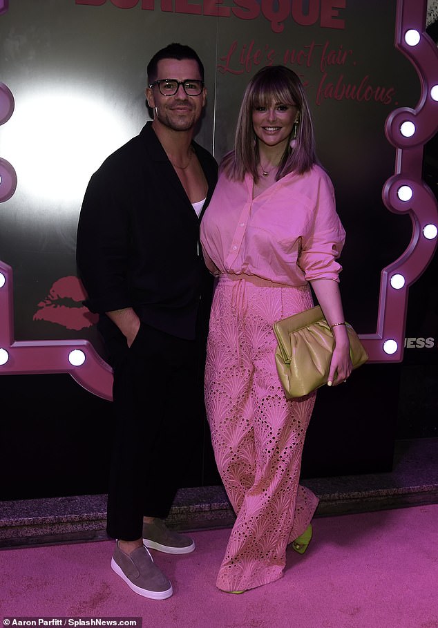 The Celebrity Big Brother star, 37, looked glamorous for her romantic outing in a fuchsia ensemble as she approached her husband for photographs.