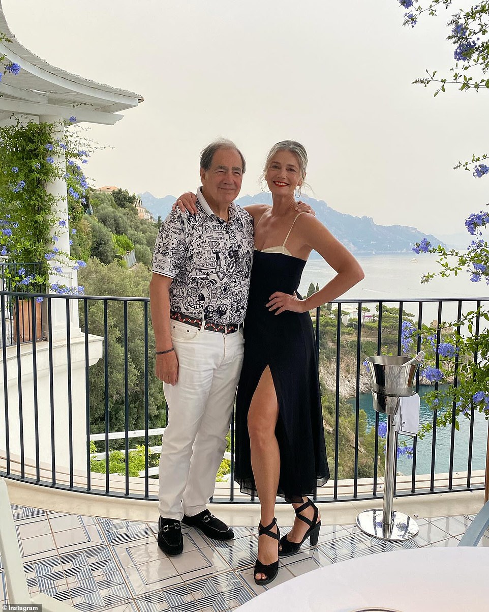 Here the star posed in a black dress with black heels while posing with her father on a balcony.