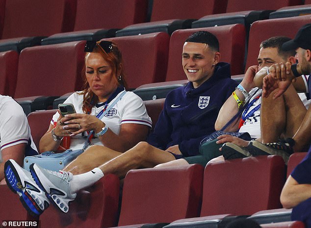 Foden appears smiling in the stands sitting with his family after England's 0-0 draw on Tuesday.