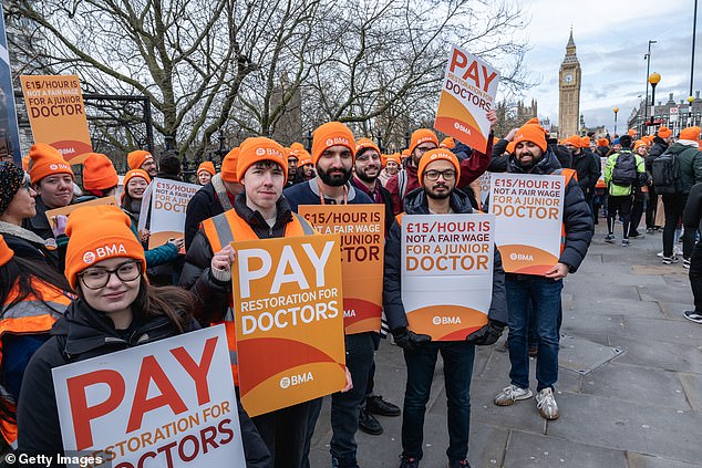 Orange hats have become synonymous with BMA picketing during previous industrial actions. Pictured are striking doctors outside St Thomas' Hospital in Westminster on February 26 earlier this year.