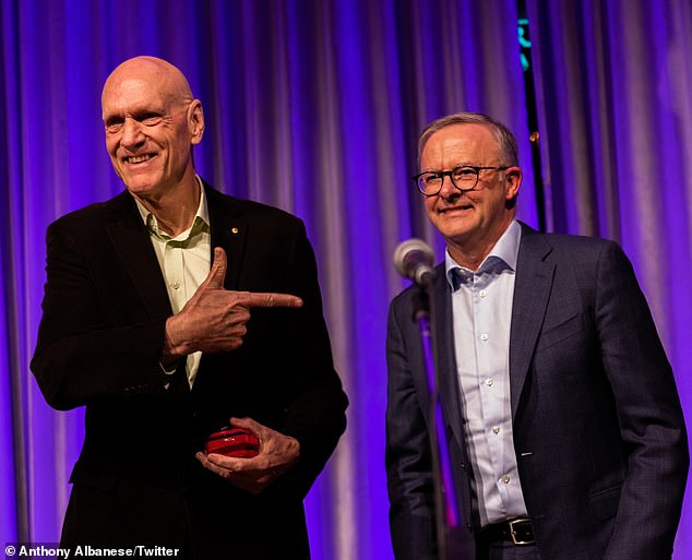 Premier Anthony Albanese has been called Midnight Oil's number one fan and presented them with a Community Excellence award. Albanese appears on the right with Midnight Oil singer and former Labor MP Peter Garrett.