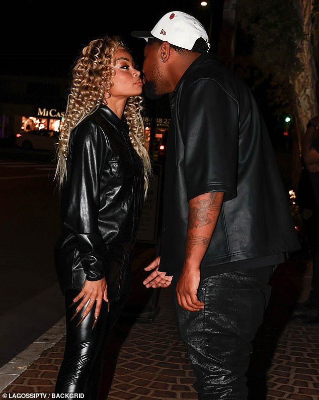 Milano coordinated with his lady in black pants, a short-sleeved black shirt, and a white cap with a black brim as he walked up to give her a kiss.