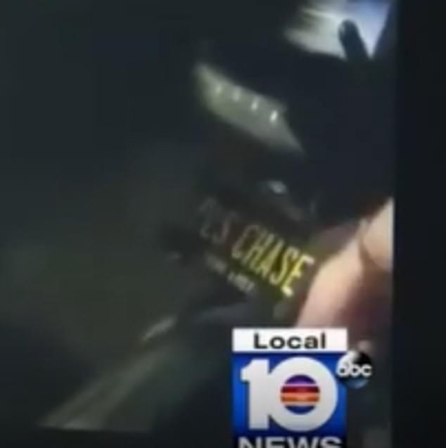 Gil's badge is seen during one of his interactions with the police. The plate says 