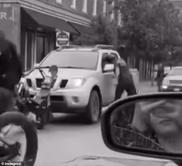 After the truck driver crashed the driver's motorcycle, they confronted the driver and slammed his head against the window in a fit of rage.