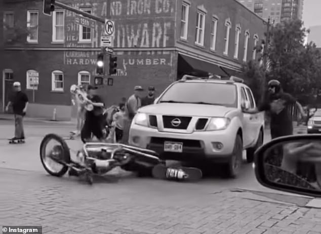 When a skateboarder hit the truck with his skateboard, the truck driver decided to accelerate forward and dragged the motorcycle down the street to get revenge.