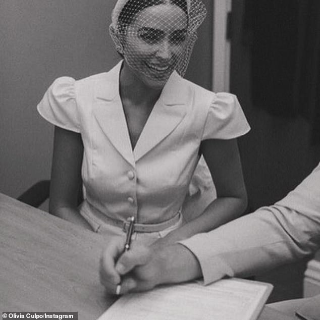 The model looked excited as she watched her new husband sign the license.