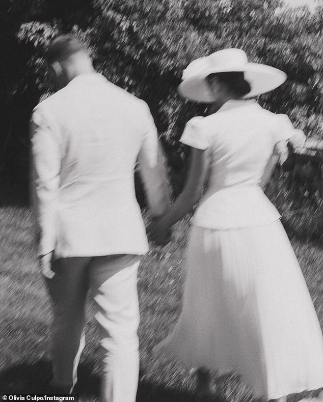 There was also a picture of the two holding hands as they walked on the grass.