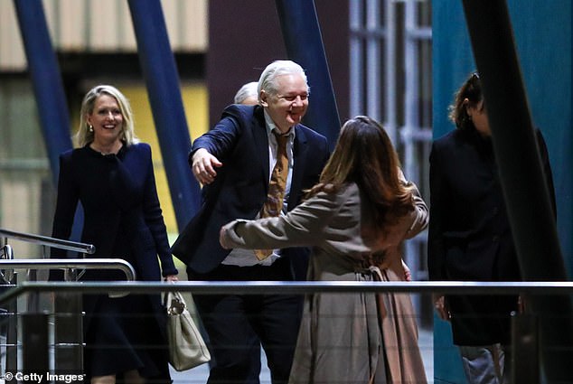 When he saw his wife Stella for the first time, the 52-year-old hugged and kissed her (pictured)