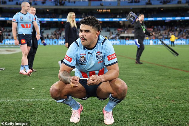 The Souths fullback is shown soaking up the atmosphere at the MCG after playing a big role in the Blues' demolition of Queensland.