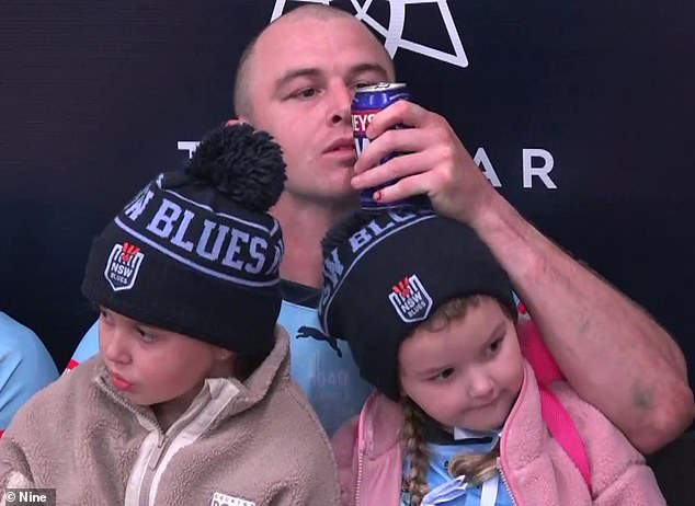 In the dugouts after the game, Dylan Edwards could be seen enjoying a sip of his beer and found a unique way to not spill a drop (pictured)