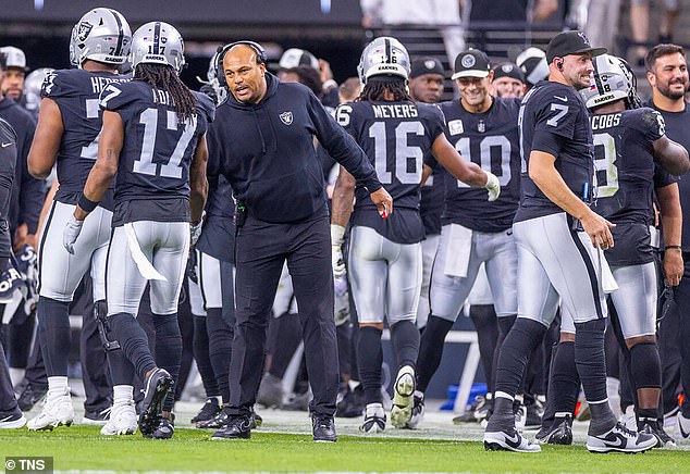 Las Vegas Raiders interim coach Antonio Pierce speaks with wide receiver Davante Adams