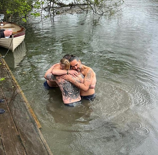 Grylls photographed taking part in a baptism ceremony for Russell Brand in the Thames (pictured)