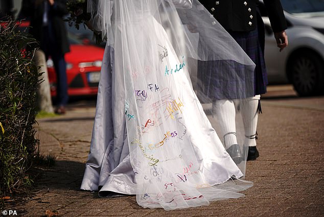 Stella's floor-length tulle veil was embroidered with messages from her friends and family that included words like 