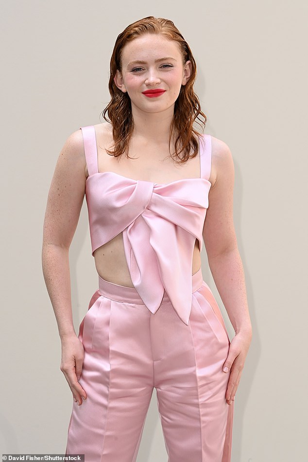 Stranger Things star Sadie looked a far cry from her tomboyish character Max Mayfield in a dusty pink crop top and matching pleated pants.