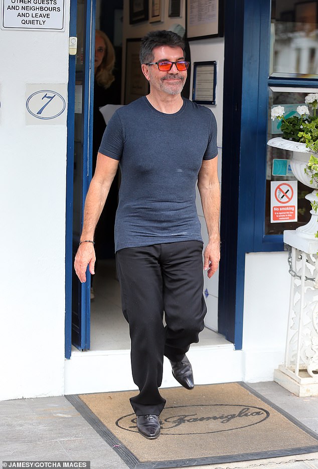 For the outing, Simon sported a casual look in a dark blue t-shirt, black pants, and sleek black shoes.