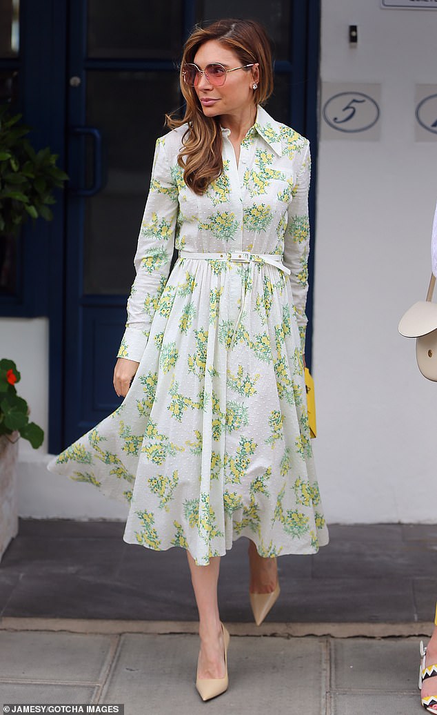 Robbie Williams' wife Ayda Field wowed in a white, green and yellow patterned dress and flattered her figure in beige court heels.