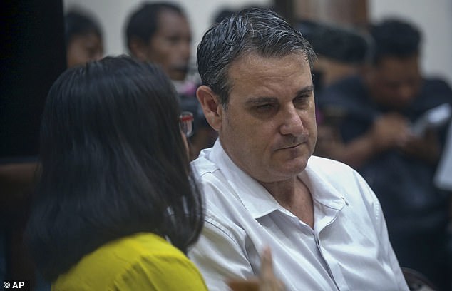 Smith is pictured listening to a member of his legal team in Bali court on Thursday.