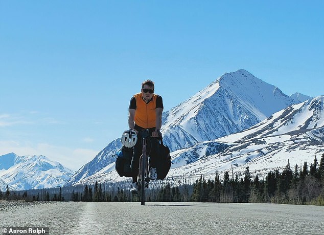 Oli completed the first leg of the trip alone, cycling across the United States and Canada to the foothills of Denali National Park. He is pictured here at Destruction Bay in the Yukon Territories of Canada.