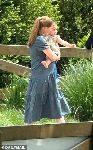 The 28-year-old's pregnant belly was already visible beneath her flowy blue midi-length dress during a family day trip.