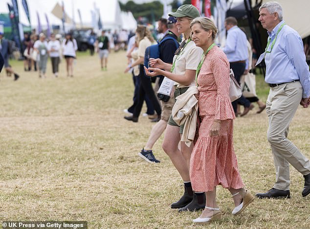 The Duchess of Edinburgh walked across the sun-baked grass in cream wedges as she chatted with a festival worker.