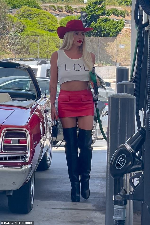 Kesha completed her summer ensemble with a red cowboy hat, a red skirt and thigh-high black boots at the gas station.