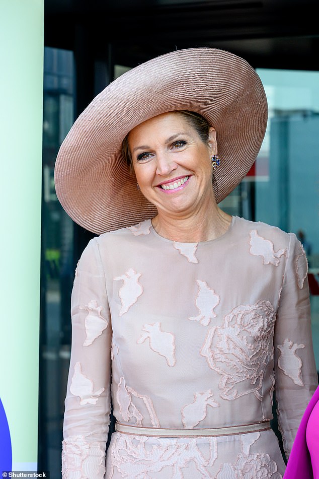 The Dutch queen wore a striking cream hat to match her elegant appliquéd dress.