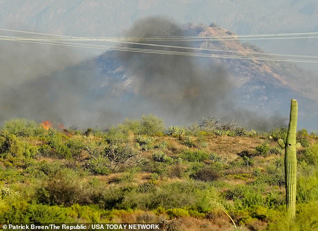 Fire peaks over hill as smoke emerges from Boulder View Fire in north Scottsdale