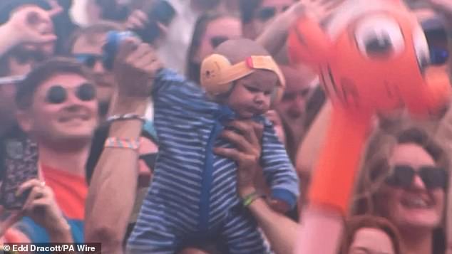 Adorable baby Finlay was greeted with cheers as he appeared on the big screen several times as Irish DJ Mac opened Worthy Farm's second largest stage.