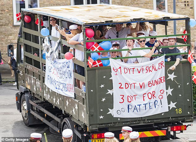 Crown Prince Christian joined his classmates on the truck as they drove around as part of the graduation festivities.