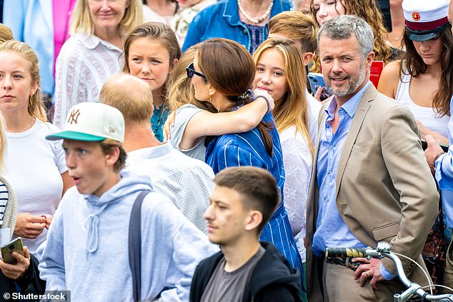 Queen Mary shared a hug with a young woman in the crowd.