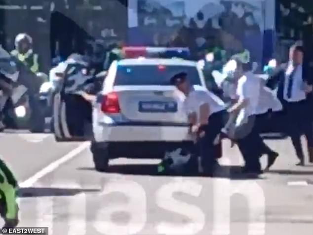 A separate clip shows other police officers running to the car to help the injured man. He reportedly did not suffer any life-threatening injuries.