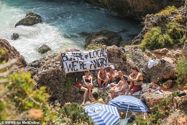 Members of the public protesting on Caló des Moro beach outside Santanyí, Mallorca, on June 16, where tourists were told: 