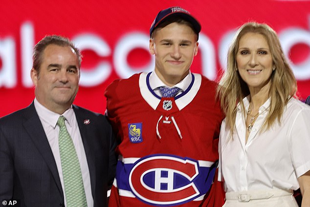 Ivan Demidov, center, poses after being selected by the Montreal Canadiens during the first round of the NHL hockey draft.