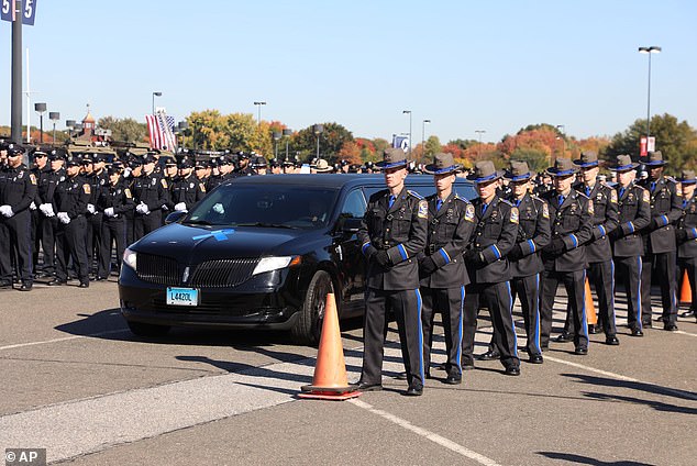 Thousands of police officers from across the country gathered at a Connecticut football stadium on Friday for the funeral of two officers who were shot dead in an ambush.