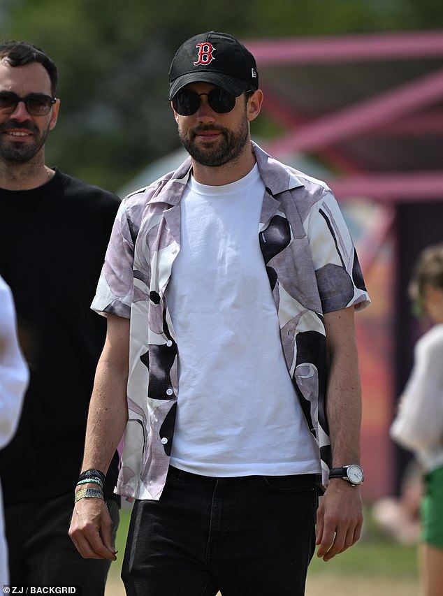 Jack Whitehall, 35, looked casual in a white T-shirt and brightly coloured shirt as he was seen strolling through the fields.