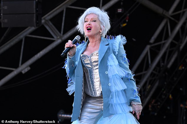 Cyndi looked amazing for the afternoon performance as she donned a silver corset with a matching pair of pants and a long blue ruffled coat.