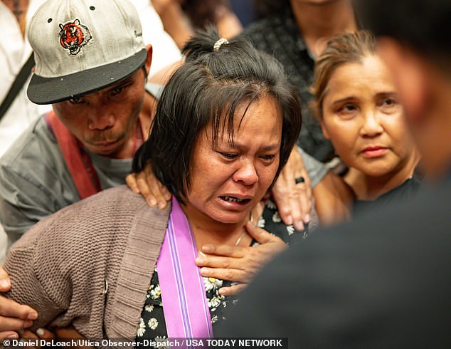 The mother of the 13-year-old boy who was shot and killed by Utica police cries after listening to a translator inside City Hall in Utica, New York, on Saturday, June 29, 2024.