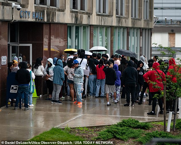 A crowd gathers in front of City Hall for a news conference in Utica, New York, Saturday, June 29, 2024.