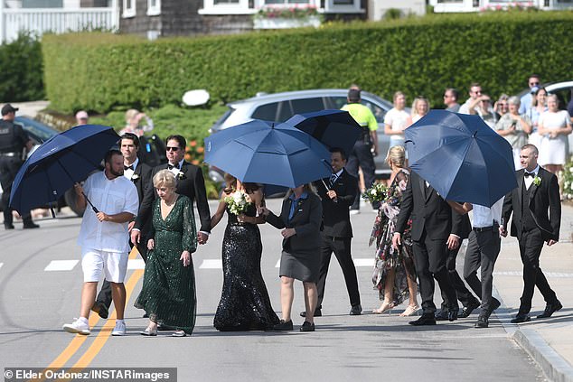 Many of the guests brought umbrellas to take a break from the heat.