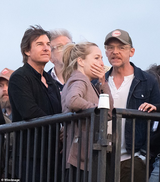 The Top Gun star looked dapper in a black open-neck shirt, while Simon sported a white T-shirt with a navy jacket and baseball cap.