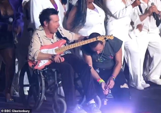 The 63-year-old Back to the Future actor, who is battling Parkinson's, appeared on stage in his wheelchair while playing guitar.