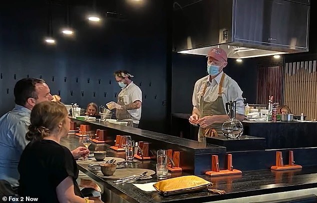 Connoley, right, is seen working in his St. Louis kitchen after the pandemic.